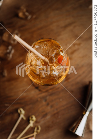 Refreshing cocktail with ice in a wine glass, top view, perfect for summer vibes and bar menus Refreshing cocktail with ice in a wine glass, top view, perfect for summer vibes and bar menus 117450572