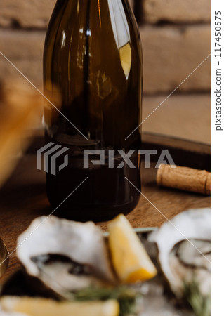 Elegant wine bottle with oysters and lemon, perfect for luxury dining and fine dining concepts Elegant wine bottle with oysters and lemon, perfect for luxury dining and fine dining concepts 117450575