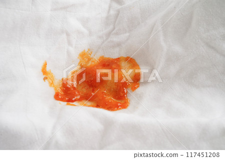 Dirty spicy sauce stain on cloth to wash with washing powder, cleaning housework concept. 117451208