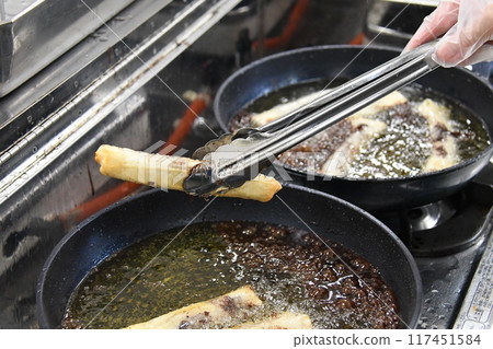 Filipino dish Turon being cooked Filipino dish Turon being cooked 117451584