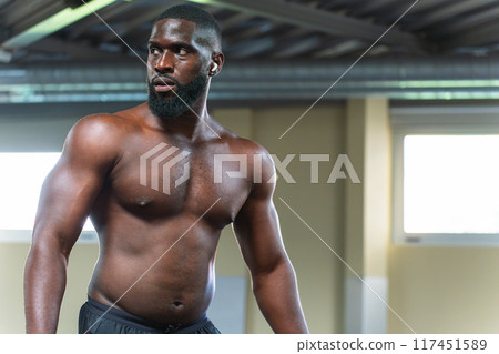 Black bodybuilder in volume stage working out at the gym 117451589