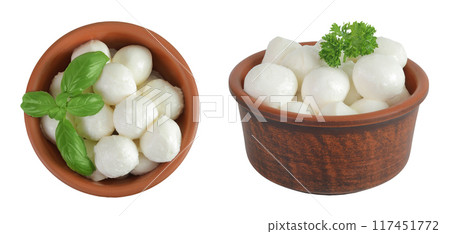 Mini mozzarella balls with basil in a ceramic bowl isolated on white background. Top view. Flat lay. 117451772