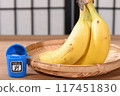Miniature trash can and fresh bananas 117451830