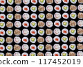 Repeating background from different types of maki sushi rolls on a black background. High quality photo 117452019
