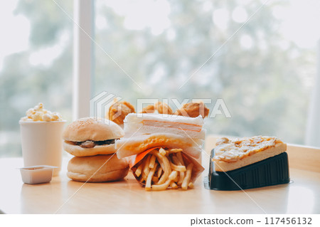Closeup of home made burgers on wooden background Closeup of home made burgers on wooden background 117456132