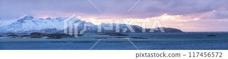 Panorama of Sommaroy islands and arctic sea near Tromso Norway. Sunset over snowy small islands Panorama of Sommaroy islands and arctic sea near Tromso Norway. Sunset over snowy small islands 117456572