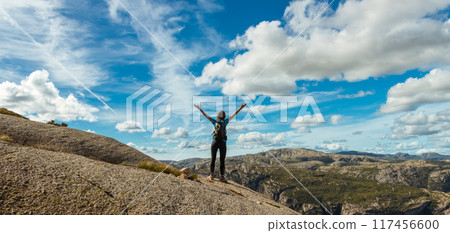 Woman successful hiking silhouette in mountains, motivation and inspiration in beautiful sunset. Female hiker with arms up outstretched on mountain top, inspirational landscape Woman successful hiking silhouette in mountains, motivation and inspiration in beautiful sunset. Female hiker with arms up outstretched on mountain top, inspirational landscape 117456600