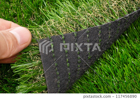Fingers Lifting Edge of Artificial Grass Fingers Lifting Edge of Artificial Grass 117456890