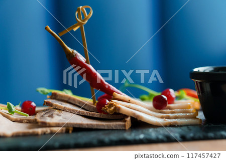 Sliced meat with sauce and breadsticks Sliced meat with sauce and breadsticks 117457427