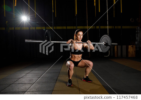 Woman with barbell Caucasian female performing deadlift exercise with barbell 117457468