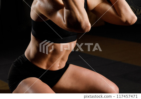 Woman with barbell Caucasian female performing deadlift exercise with barbell 117457471