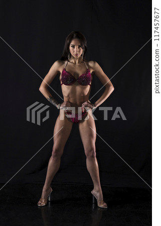 Beautiful athletic girl on a dark background 117457677