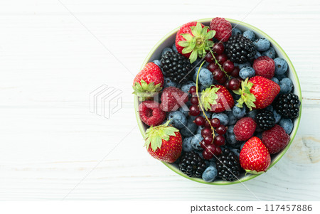 Mix of ripe colorful berries in bowl photography . Blueberry , strawberry , raspberry , blackberry and red currant . Top view Mix of ripe colorful berries in bowl photography . Blueberry , strawberry , raspberry , blackberry and red currant . Top view 117457886