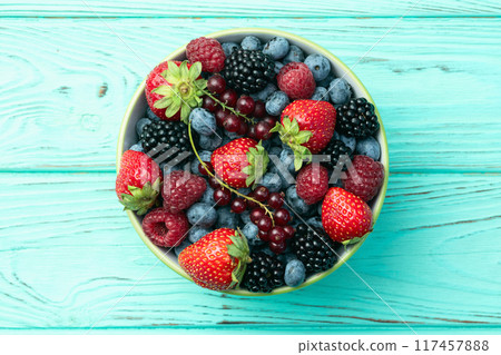 Mix of ripe colorful berries in bowl photography . Blueberry , strawberry , raspberry , blackberry and red currant . Top view Mix of ripe colorful berries in bowl photography . Blueberry , strawberry , raspberry , blackberry and red currant . Top view 117457888