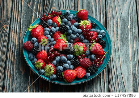 Mix of ripe colorful berries in bowl photography . Blueberry , strawberry , raspberry , blackberry and red currant . Top view Mix of ripe colorful berries in bowl photography . Blueberry , strawberry , raspberry , blackberry and red currant . Top view 117457896
