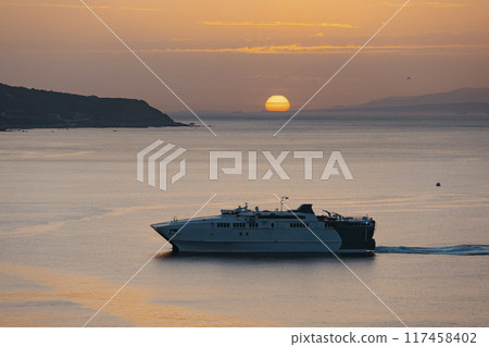 View of a ferry at sunset entering the port of Ceuta 117458402