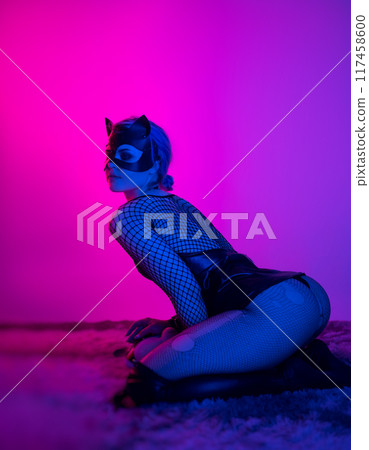 sexy girl in costume and mask bdsm games in neon light with empty background sexy girl in costume and mask bdsm games in neon light with empty background 117458600