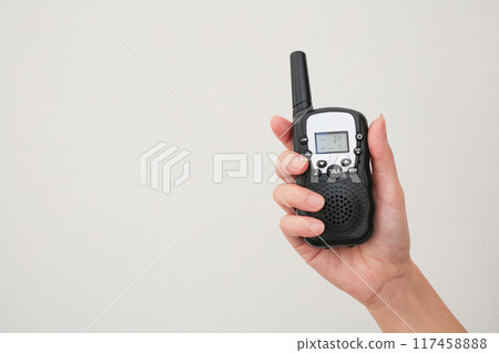Image of a hand holding a radio 117458888