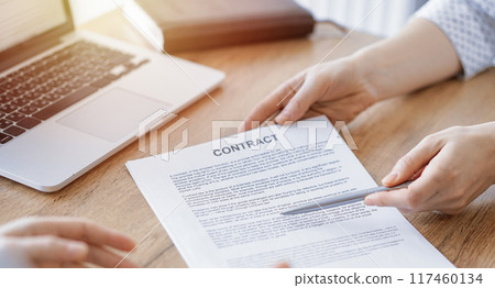 Businesswoman lawyer pointing into contract special points admitting something for colleague or client at the wooden desk in office. Business people teamwork and partnership, meeting concept Businesswoman lawyer pointing into contract special points admitting something for colleague or client at the wooden desk in office. Business people teamwork and partnership, meeting concept 117460134