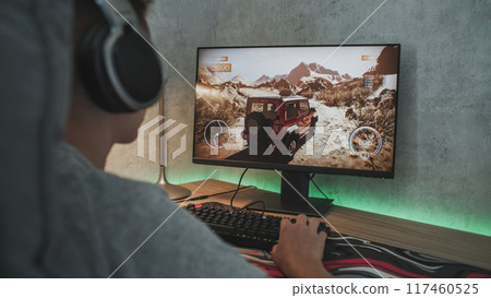 Caucasian teen enjoys gameplay in off road racing simulator Caucasian teen enjoys gameplay in off road racing simulator 117460525