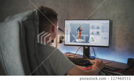 Teenage boy creates and draws clothes using design software on PC Teenage boy creates and draws clothes using design software on PC 117460531