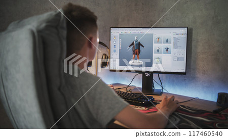 Teenage boy creates and draws clothes using design software on PC Teenage boy creates and draws clothes using design software on PC 117460540