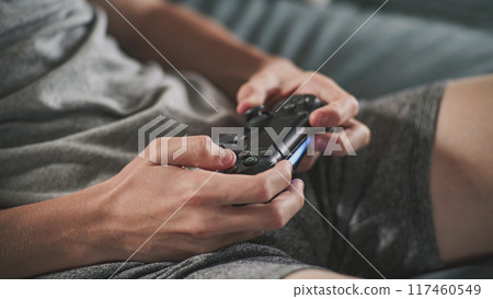 Close up hands of Caucasian young boy using wireless controller Close up hands of Caucasian young boy using wireless controller 117460549