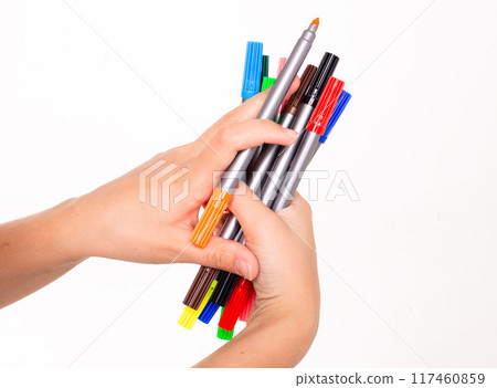 set of colored markers in hands on a white background 117460859