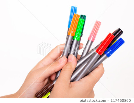 set of colored markers in hands on a white background set of colored markers in hands on a white background 117460860