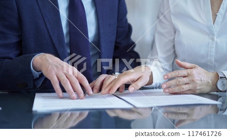Business people and lawyers a contract papers before signing the agreement. Teamwork concept Business people and lawyers a contract papers before signing the agreement. Teamwork concept 117461726