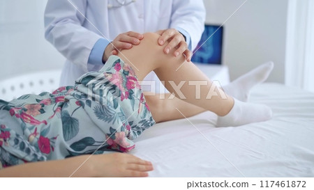 Doctor and kid patient. Orthopedist examining girl's knee in medical clinic. Medicine and health care Doctor and kid patient. Orthopedist examining girl's knee in medical clinic. Medicine and health care 117461872