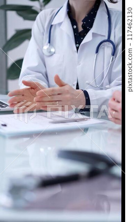 Doctor and patient are sitting and talking at the glass table, Medicine and health care concept 117462130