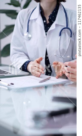 Doctor and patient are sitting and talking at the glass table, Medicine and health care concept Doctor and patient are sitting and talking at the glass table, Medicine and health care concept 117462135
