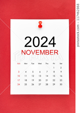 November 2024 calendar page with push pin on red background. November 2024 calendar page with push pin on red background. 117462868