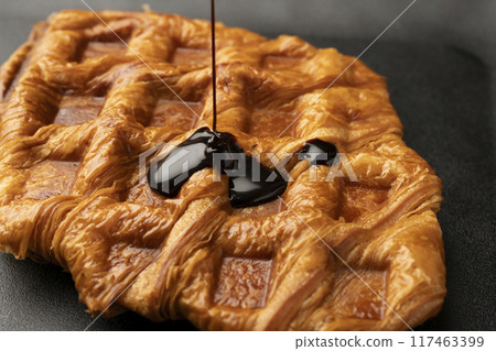 Freshly baked croffles with chocolate sauce 117463399