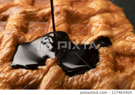 Freshly baked croffles with chocolate sauce 117463404