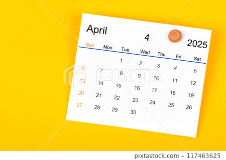 April 2025 and wooden push pin on yellow. April 2025 and wooden push pin on yellow. 117463625