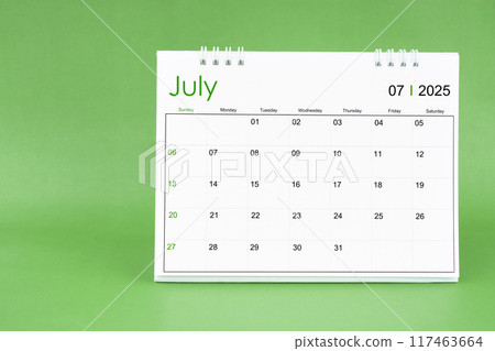 July 2025 desk calendar isolated in green background. July 2025 desk calendar isolated in green background. 117463664