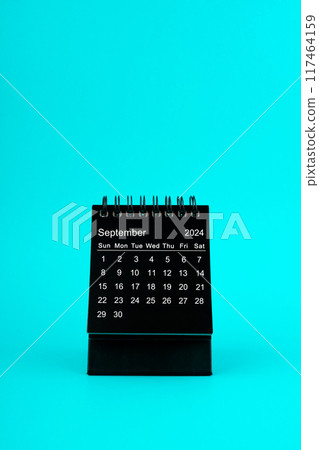 Black Calendar for September 2024. Desktop calendar on a green background. 117464159