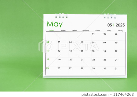 May 2025 desk calendar isolated in green background. May 2025 desk calendar isolated in green background. 117464268