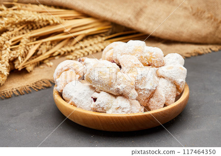 Powdered sugar-coated pastries filled with jam, perfect for sweet cravings and dessert lovers Powdered sugar-coated pastries filled with jam, perfect for sweet cravings and dessert lovers 117464350