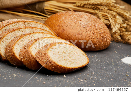 Whole wheat bread loaf sliced, showcasing its hearty texture and rich, wholesome flavor 117464367