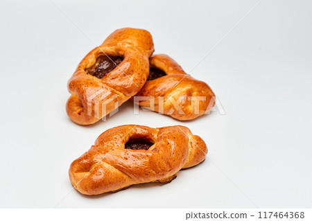 Golden-brown pastries filled with fruit jam, perfect for a delicious breakfast or sweet snack 117464368