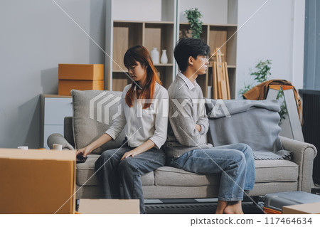 Offended couple ignoring each other after quarrel indoors, selective focus. Relationship problems 117464634