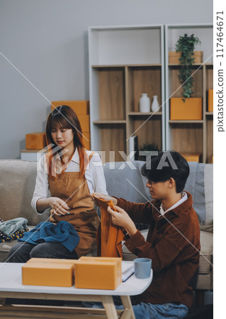 Small business owners couple entrepreneurs working with parcel, e-business, marketing, online shop, sme, entrepreneurs 117464671