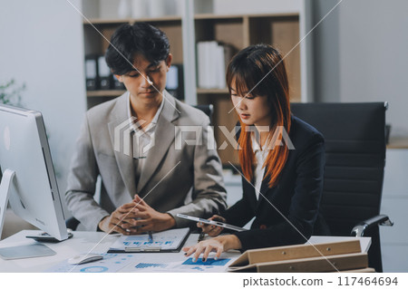 Entrepreneur Asian businessman and businesswoman discussing new business project in tablet in modern Meeting In Modern Office, Asian business casual concept. Entrepreneur Asian businessman and businesswoman discussing new business project in tablet in modern Meeting In Modern Office, Asian business casual concept. 117464694