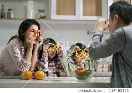 young asian family with two children having a good time in kitchen at home 117465335