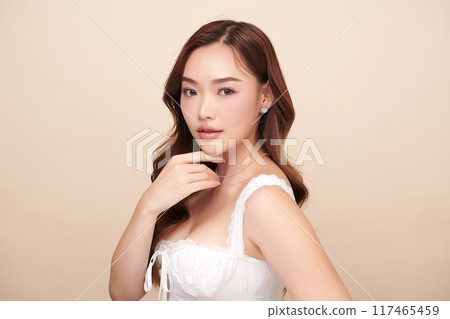 Beautiful young asian woman with clean fresh skin on beige background, Face care, Facial treatment, Cosmetology, beauty and spa, Asian women portrait. Beautiful young asian woman with clean fresh skin on beige background, Face care, Facial treatment, Cosmetology, beauty and spa, Asian women portrait. 117465459