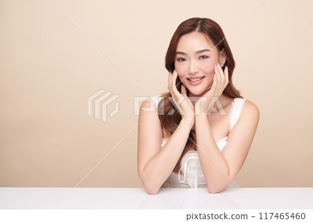 Beautiful young asian woman with clean fresh skin on beige background, Face care, Facial treatment, Cosmetology, beauty and spa, Asian women portrait. Beautiful young asian woman with clean fresh skin on beige background, Face care, Facial treatment, Cosmetology, beauty and spa, Asian women portrait. 117465460