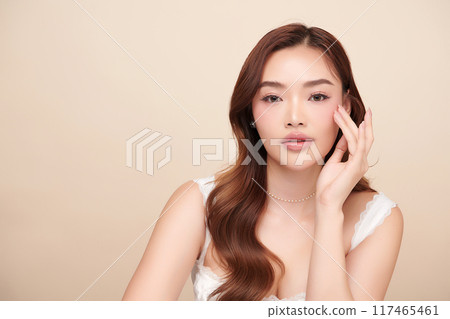 Beautiful young asian woman with clean fresh skin on beige background, Face care, Facial treatment, Cosmetology, beauty and spa, Asian women portrait. 117465461